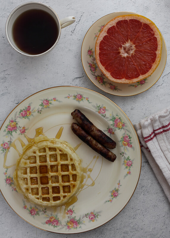 1940s Breakfast with grapefruit, waffles, sausage, and coffee