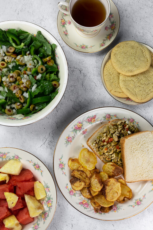 1940s Supper with salad, potato chips, olive and nut sandwiches, cookies, fruit, and tea